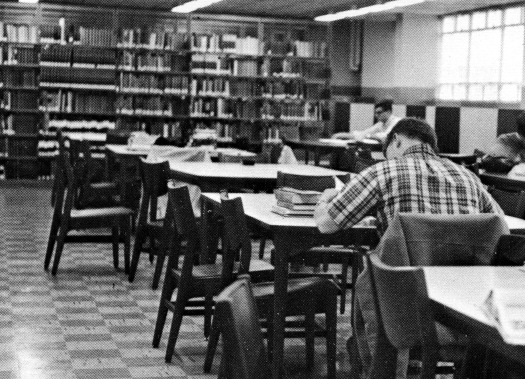 black and white photo of tables and chairs and book stacks at Heindel, Penn State Archives