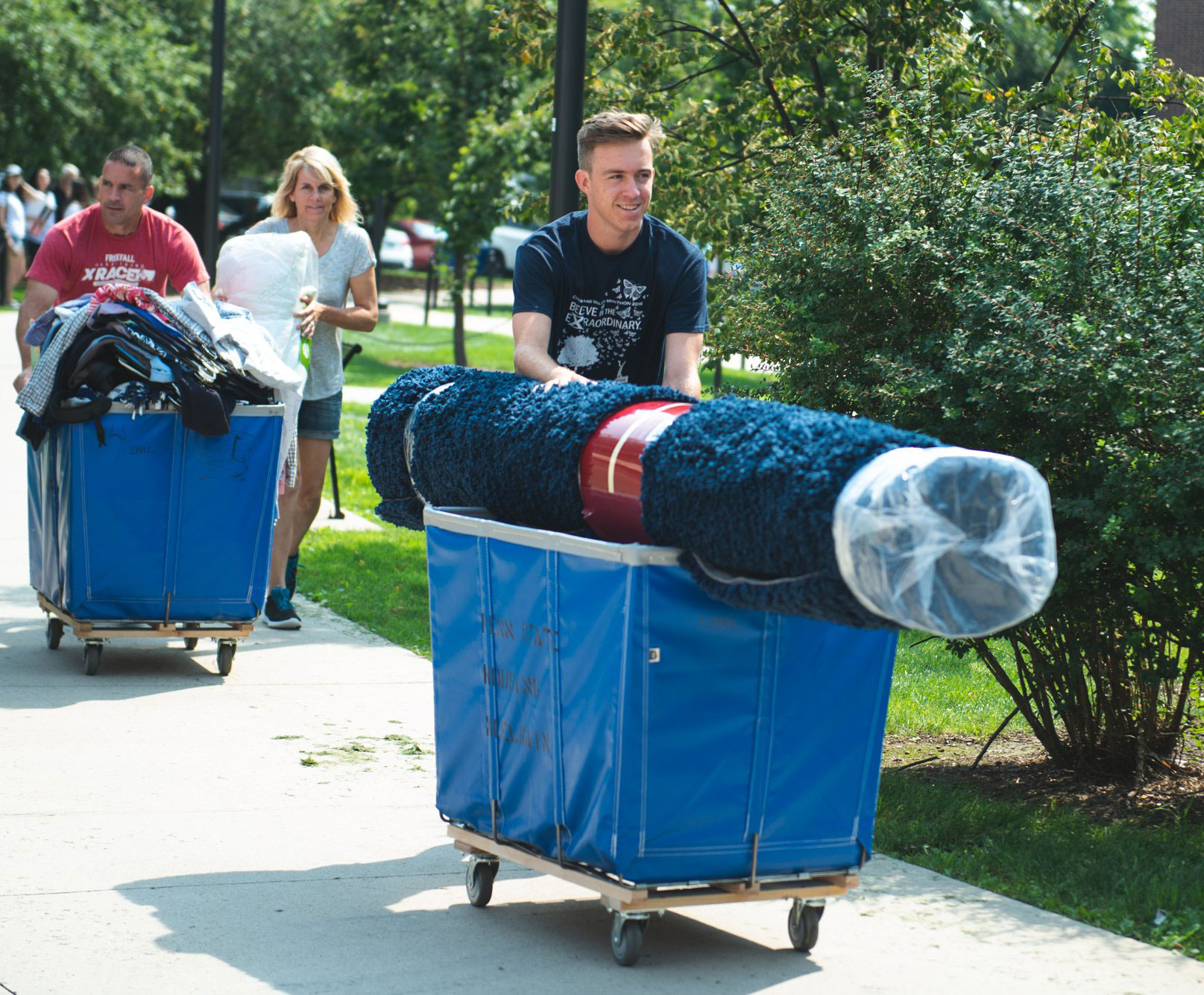 a student transporting dorm items during move-in week by Penn State