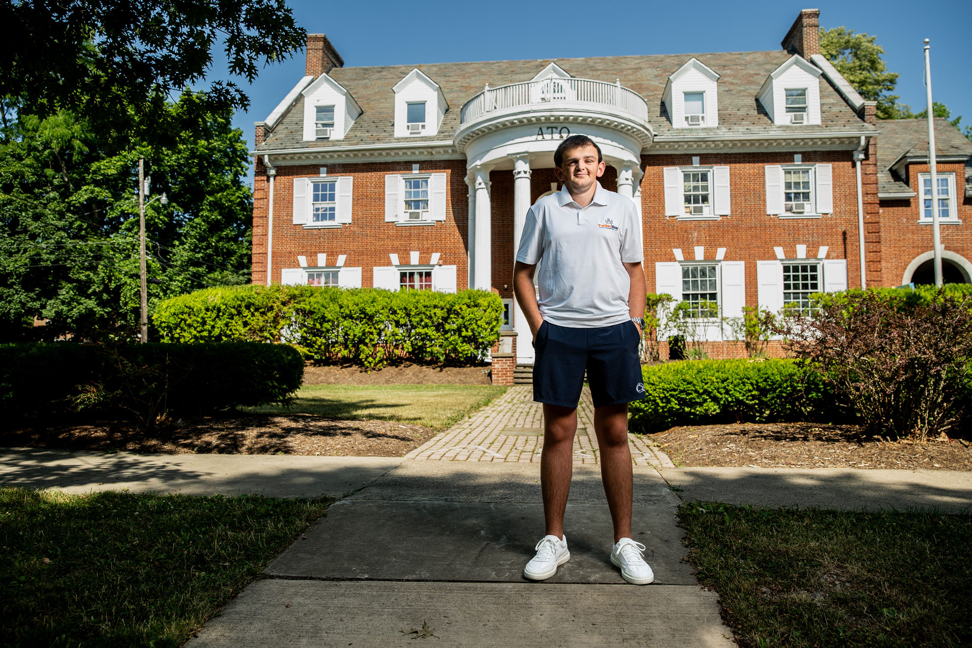 Tucker Haas standing outside Alpha house by Cardoni