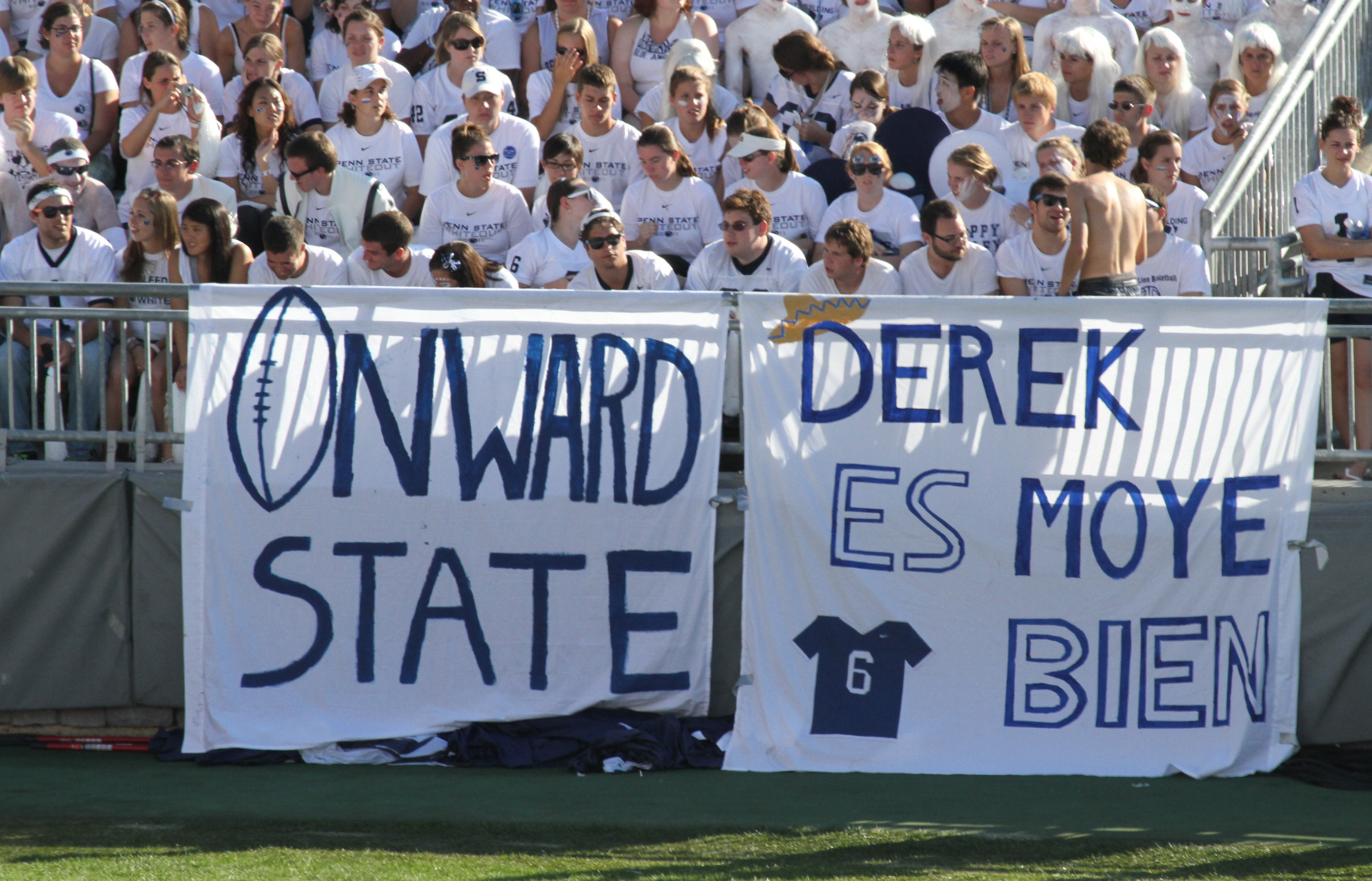 photo of students in bleacher seats with a blue and white Onward State banner, photo by STEFAN CHOQUETTE