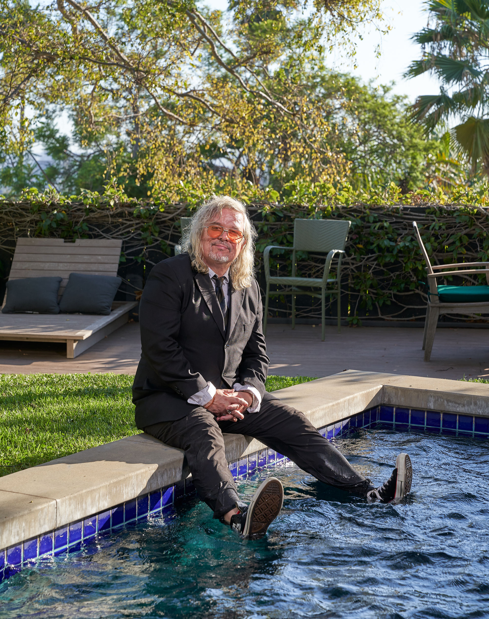 photo of Walker seated with feet in his pool by Gregg Segal