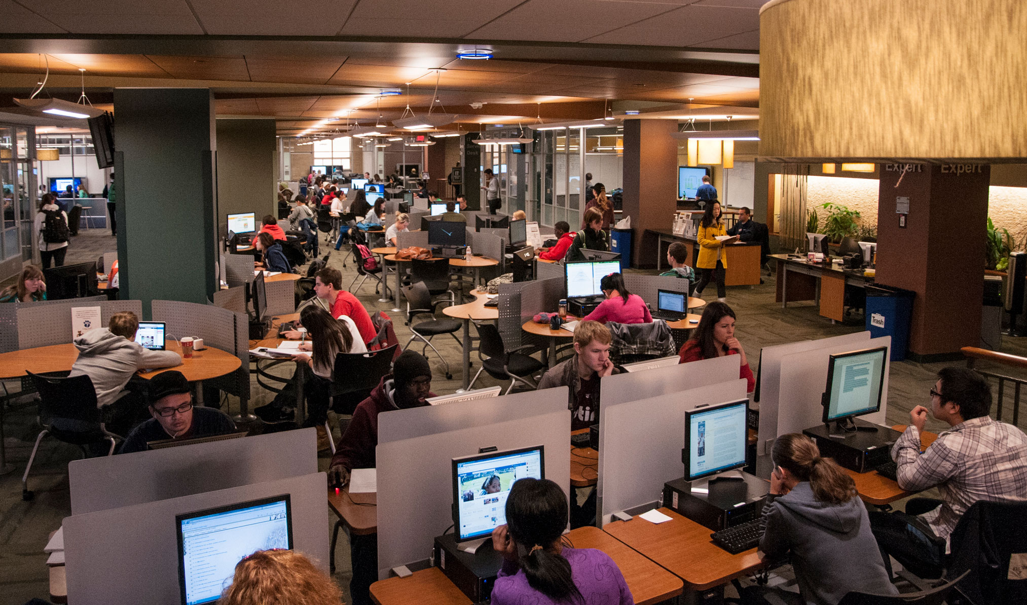 photo of busy library with dozens of full work stations by Penn State Libraries