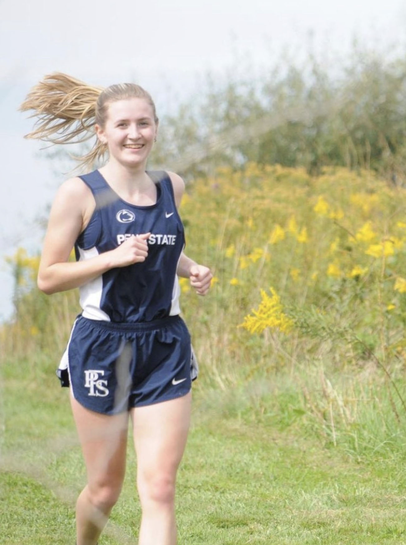 female cross-country runner in Penn State uniform by Michelle Bixby