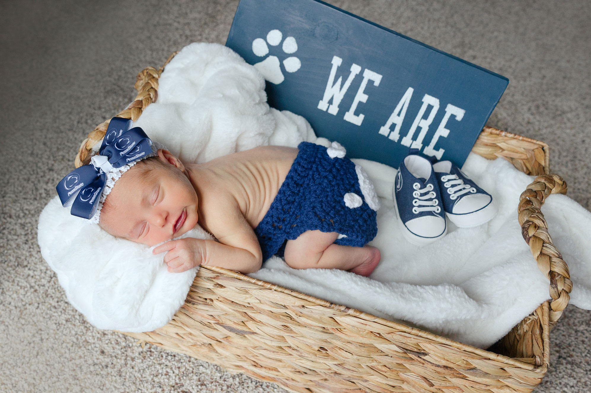 D'Amico baby in Penn State clothing in a basket, courtesy
