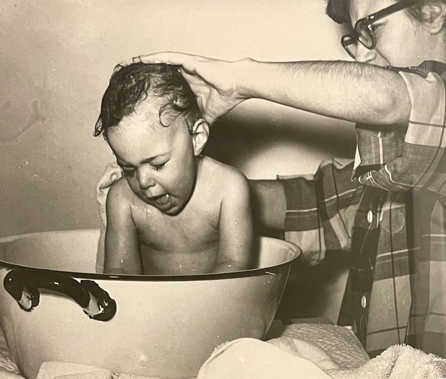sepia photo of a baby being bathed in a wash basin, courtesy Nancy Taylor