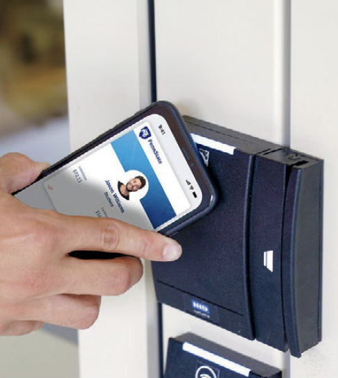 photo of a student holding a mobile phone with digital ID card on it up to a card reader on a building's door, by Penn State