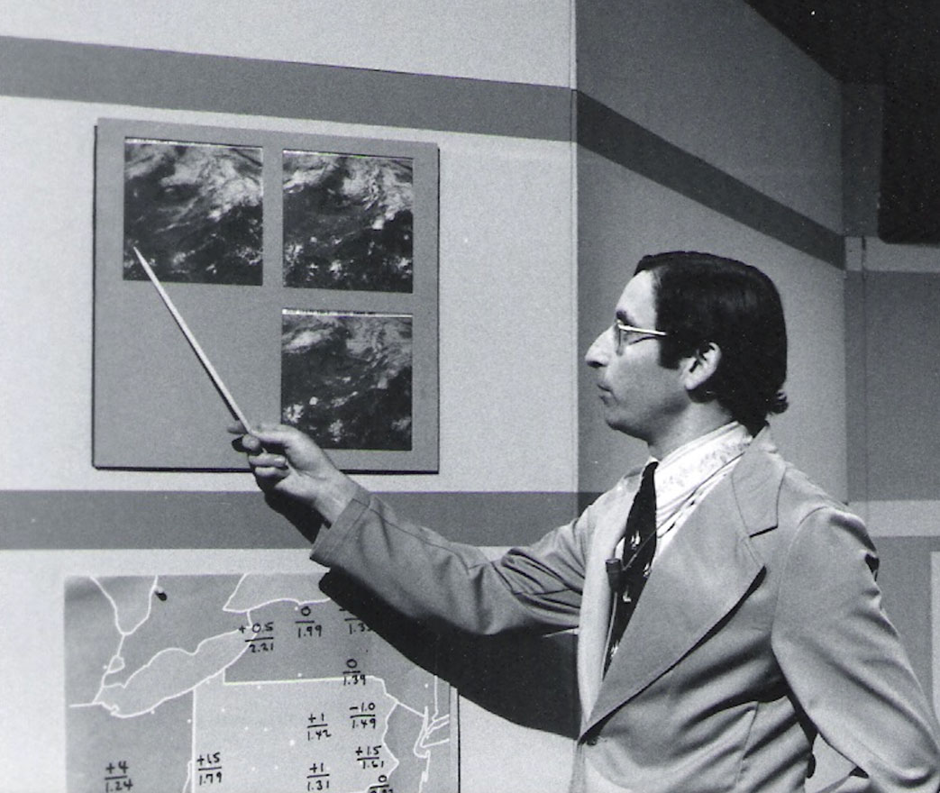 Black and white photo of Joel Myers on Weather World in the 1980s, by Penn State Archives