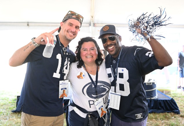 three Penn State fans in jerseys with shakers, photo by Steve Manuel '84 Lib, '92 MA Com