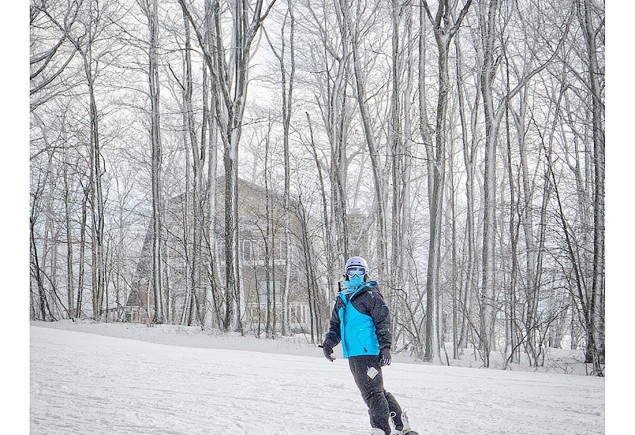 photo of snowboarder in blue jacket