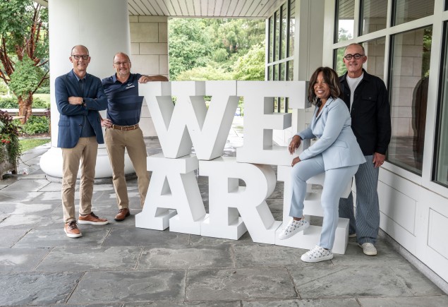 photo of alumni guests on The CMO Podcast posing with large white We Are letters during ALC 2025, photo by Penn State Alumni Association