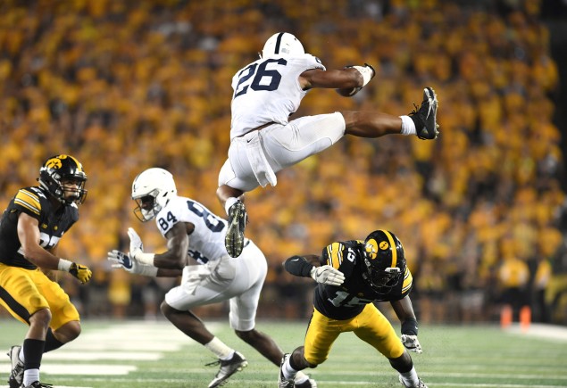 Barkley jumping over Iowa defender, photo by Steve Manuel ’84 Lib, ’92 MA Com
