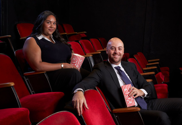 photo of two Hollywood Program alums seated in a theater of red seats by Gregg Sega