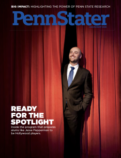 cover of July / August 2026 issue of Penn Stater magazine featuring an alum in a suit stepping out from behind a red curtain, photo by Gregg Segal