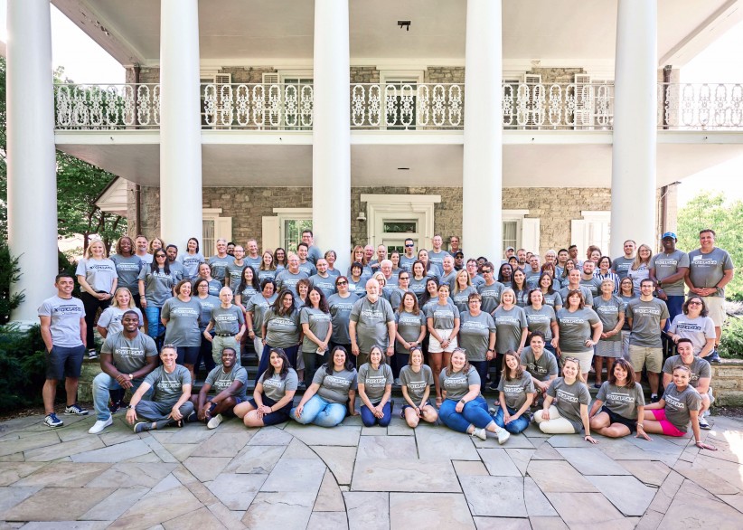 attendees of the 2022 Alumni Leadership Connections Conference gathered in front of the porch entrance to University House at Hintz Family Alumni Center, courtesy Penn State Alumni Association