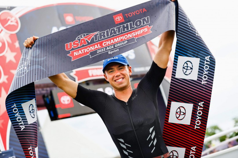 Matt Guenter holding up USA Triathlong national championship banner courtesy Guenter / USA Triathlon