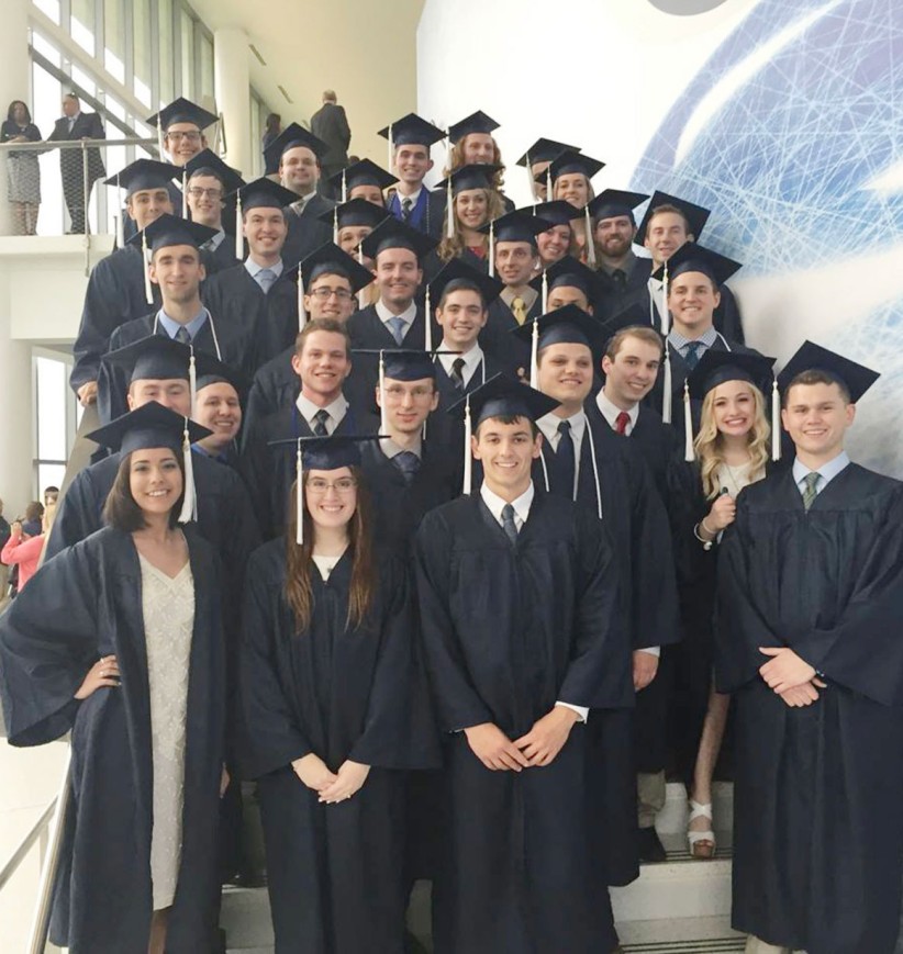 commencement photo of students in caps and gowns, by Penn State