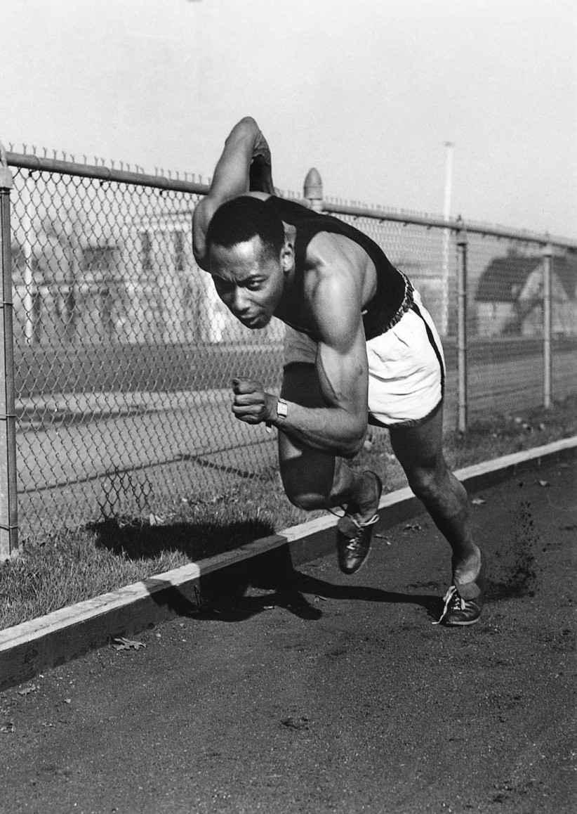 Black and white photo of Barney Ewell running on track by Penn State Archives