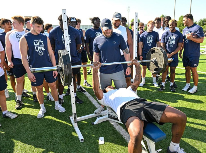 Penn State athletes lifting weights, photo by Mark Selders