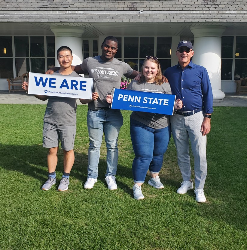 photo of alums holding We Are and Penn State signs, courtesy Alumni Career Services