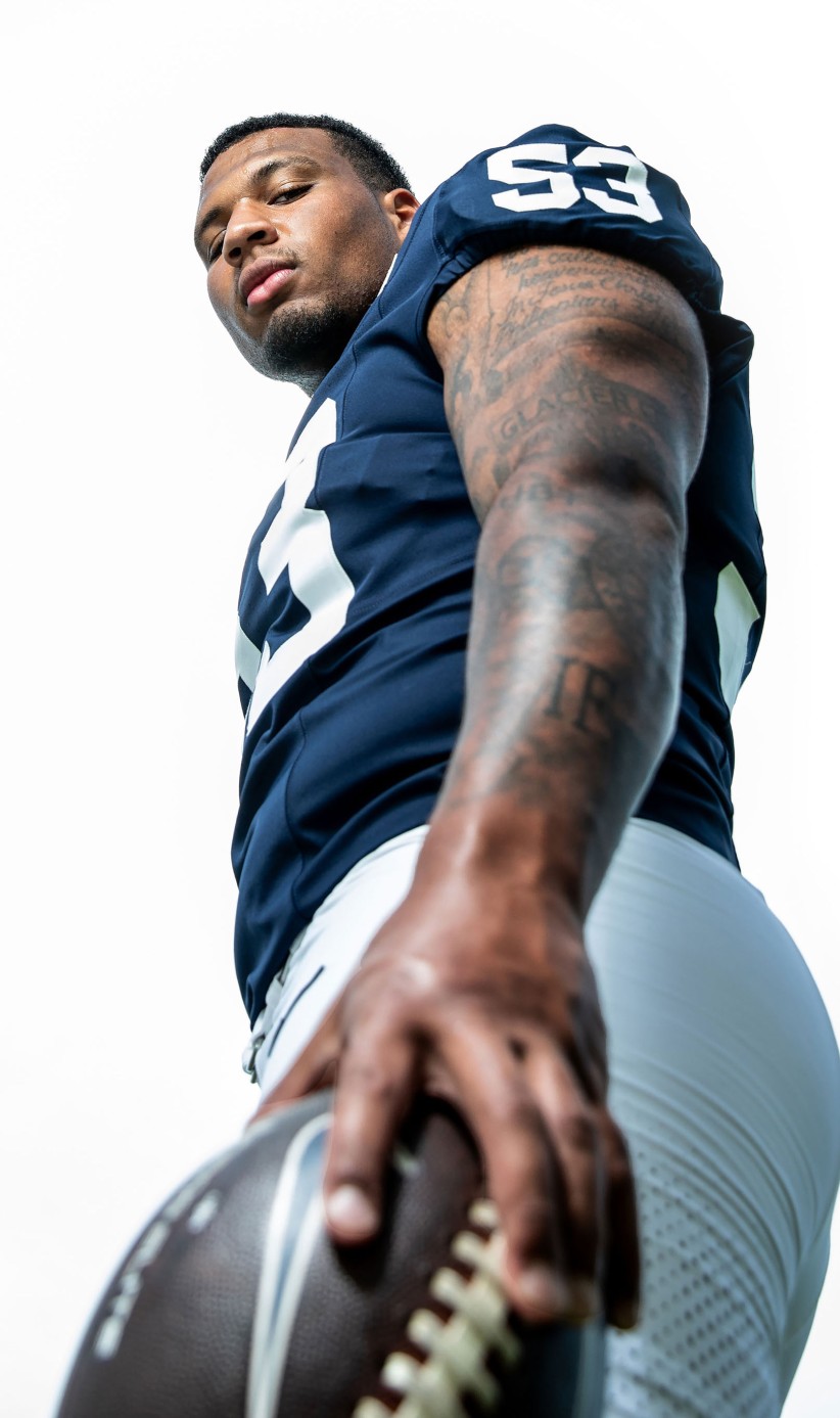 ground view of Nick Dawkins in uniform looking down at camera by Cardoni