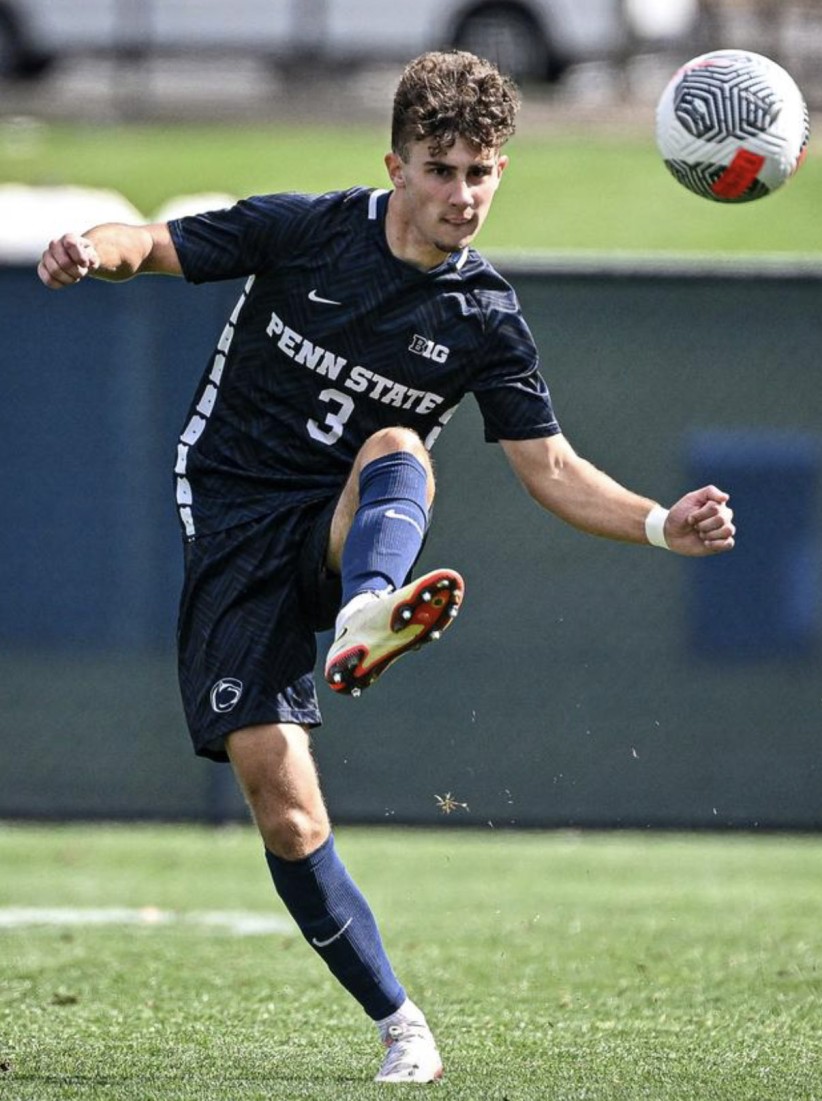 Matthew Henderson kicking soccer ball, photo by Penn State Athletics