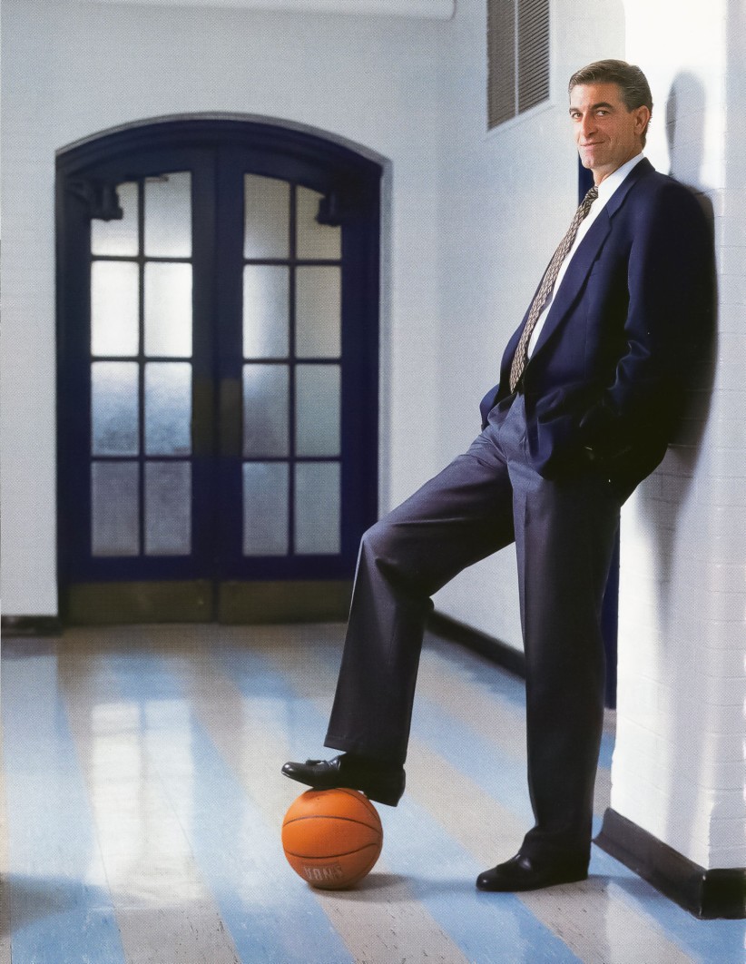 Bruce Parkhill leaning against a wall with right foot resting on a basketball by Dan Oleski '87 A&A