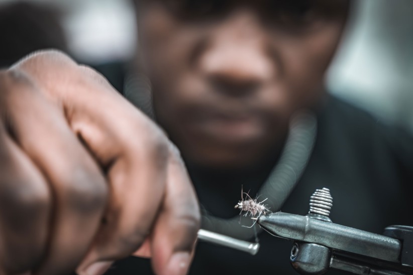 closeup of hands tying a fly fishing lure courtesy George Daniels