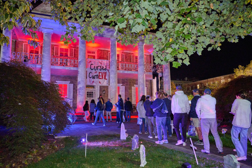 photo of University House lit up with Halloween lights as part of Haunted Valley 2025, photo by Penn State Alumni Association