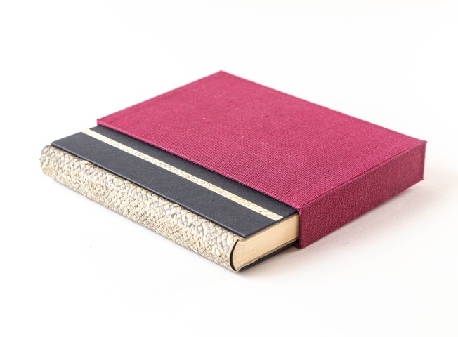 Photo of a book bound with salmon skin in a red box, by Nick Sloff '92 A&A.