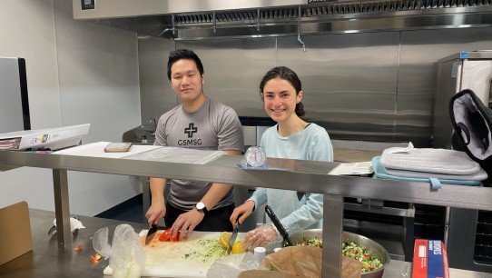 Penn State students doing food prep in kitchen