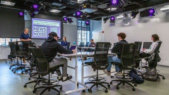 News Literacy Ambassadors sitting around a table during production of a News Over Noise podcast, photo by Nick Sloff '92 A&A