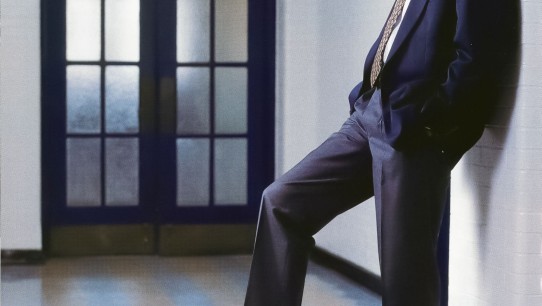 Bruce Parkhill leaning against a wall with right foot resting on a basketball by Dan Oleski '87 A&A