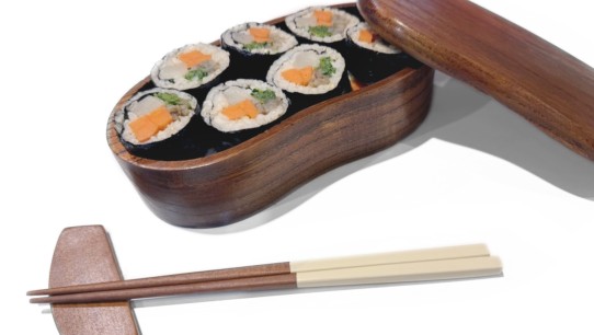 photo of a wooden lunch box with sushi and chopsticks, courtesy