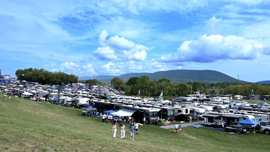 wide shot of tailgaters against backdrop of Mount Nittany by Penn State Alumni Association