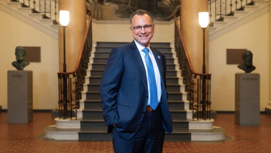 Fotis Sotiropoulos standing before large staircase in Old Main, photo by Michael Owen/Penn State