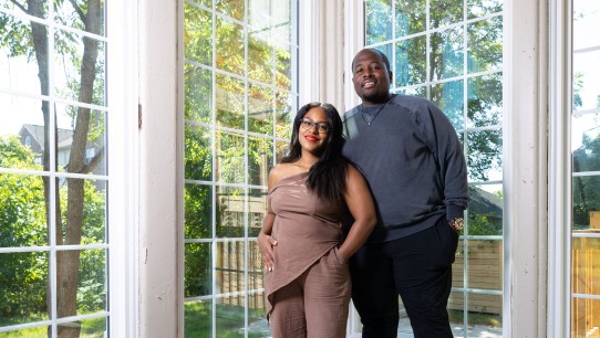 photo of the Greens in their home with floor to ceiling windows by Michael Lewis