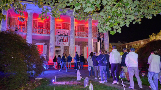 photo of University House lit up with Halloween lights as part of Haunted Valley 2025, photo by Penn State Alumni Association