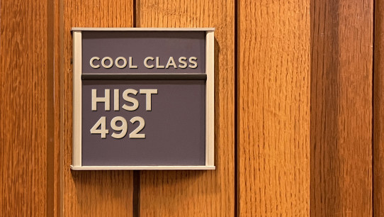 blue classroom sign that reads HIST 492