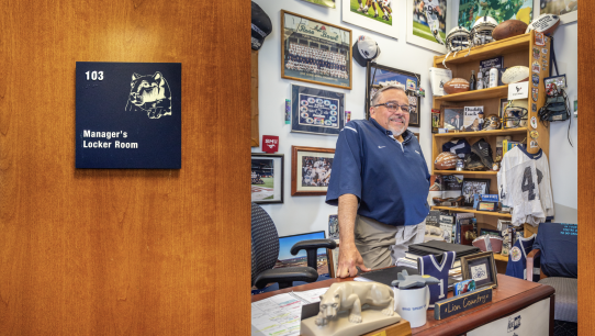 opening spread of Keeper of the Flame featuring a photo of Caldwell's office door and Caldwell standing behind desk inside with PSU football memorabilia on wall and desk by Nick Sloff '92 A&A