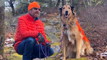 Mike Hermann pictured with his dog in the woods, courtesy Hermann