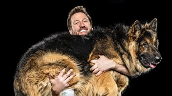 Derrick Campana holding Petey, a king shepherd who was born with one foot missing, photo by Steve Boyle