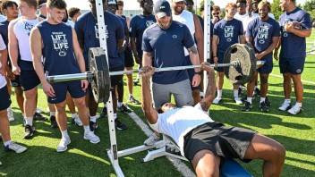 Penn State athletes lifting weights, photo by Mark Selders