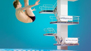 person diving into a swimming pool with tiered diving boards in the background, photo illustration by Nick Sloff ’92 A&A / Penn State Swimming & Diving