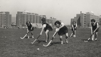 Black and white photo of the first PSU women's field hockey team on the field, by Penn State Archives