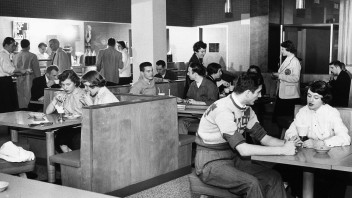 Black and white photo of students dining in the HUB, by Penn State