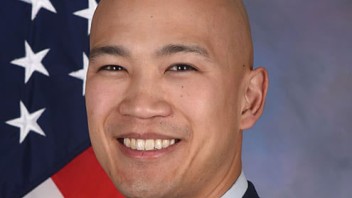 head shot of Timothy Truong in front of American flag, courtesy