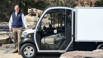 Mark Wagner standing next to an electric vehicle, courtesy