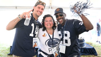 three Penn State fans in jerseys with shakers, photo by Steve Manuel '84 Lib, '92 MA Com