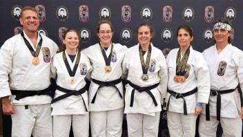 group photo of Karate Club competitors Estes, Gabel, Egan, Decker, Jennifer Koszarsky, and Jaeson Koszarsky, by Penn State Karate Club