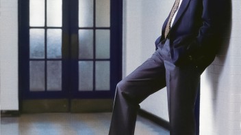 Bruce Parkhill leaning against a wall with right foot resting on a basketball by Dan Oleski '87 A&A